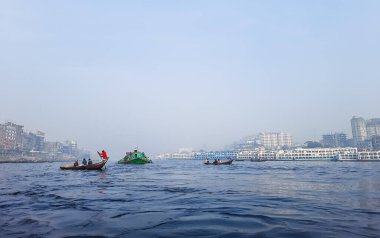 Sadarghat nehri manzarası, nehirden geçen küçük tekneler, muson yağmurlarında banliyö feribotu, Buriganga nehrinde tekne gezisi..