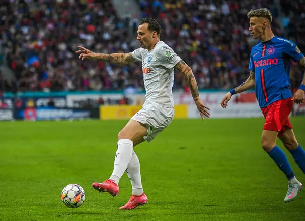 Octavian Popescu (R) ve Gjoko Zajkov (L), 17 Mayıs 2025 'te Bükreş' teki Ulusal Arena 'da düzenlenen Romanya Superliga karşılaşmasında çekildi..