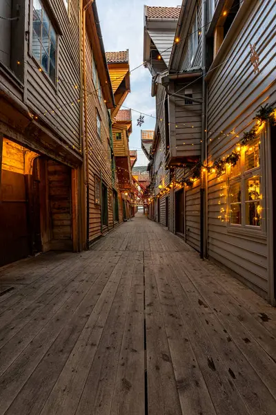 Dar bir cadde, ahşap binalar ve sicim lambalarıyla