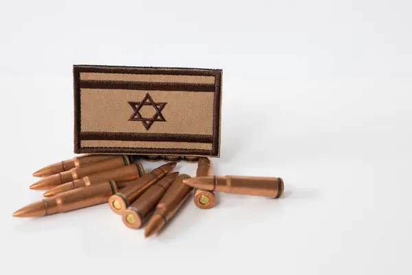 Israel flag with rifle ammunition. War between Israel and Lebanon. 7.62x39 rifle bullets ammunition. IDF military. Conflict situation and attacks. Crisis.