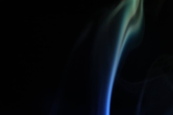 Yellow and blue smoke on a dark background, colourful abstract