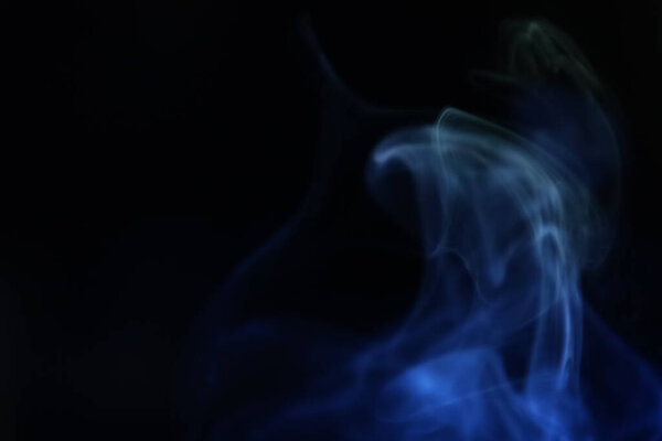 Yellow and blue smoke on a dark background, colourful abstract, fog minimalistic background