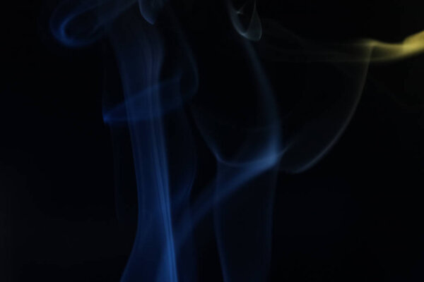 Blue fog, colored smoke on a dark background, abstract smoke shapes