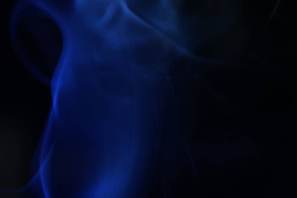 Blue fog, colored smoke on a dark background, abstract smoke shapes