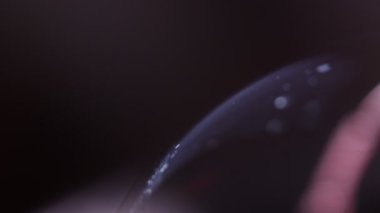 Karanlıkta gümüş sıvı partiküller, makroda baloncuk, baloncukta sıvı hareketi, soyut arkaplan, uzayı kopyala