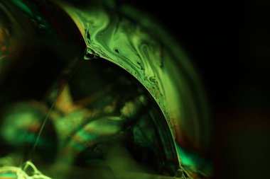 Koyu arkaplanda yeşil sıvı yüzey, makroda sıvının parlak yansımaları, makroda kabarcıklar, makroda baloncukların bağlantısı, sıvıdan hücre, koyu arkaplan