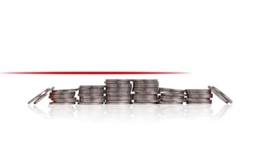 A pile of coins and a heartbeat graphic. Concept of economic crisis management.