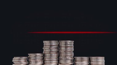 Business concept with heartbeat graph. A pile of coins and graphics.