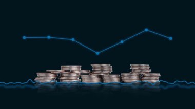 The concept of a faltering economy. A pile of coins and a graph.