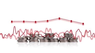 The concept of a faltering economy. A pile of coins and a graph.
