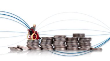 A miniature man in a wheelchair on a pile of coins. Concept on the difficulty of economic activities of the disabled.