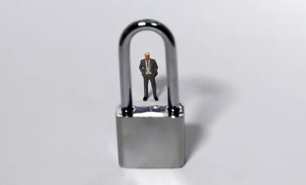 A lock and a businessman against a white background. The concept of personal information. Business and security concepts.