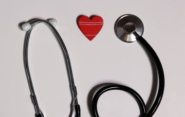 Stethoscope and red heart on white background. Cardiology and Healthcare concept. clipart