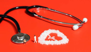 Obese people are more vulnerable to cardiovascular disease. Stethoscope on red background, salt in the shape of electrocardiogram, miniature people. clipart