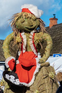 Trakai, Vilnius, Lithuania - February 19 2022: Traditional puppet made of straw preparing pancakes in Lithuania during Uzgavenes, a Lithuanian folk festival during Carnival, seventh week before Easter
