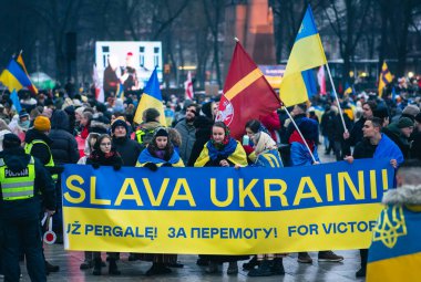 Vilnius  Lithuania - February 24 2023: People with Ukrainian flags in Vilnius Cathedral square during a manifestation against war, one year anniversary from the invasion