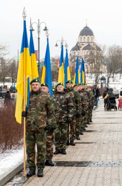 Kyiv, Ukrayna - 11 Mart 2023: Askeri üniformalı askerler Ukrayna bayraklı, dikey