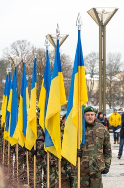Kyiv, Ukrayna - 11 Mart 2023: Askeri üniformalı askerler Ukrayna bayraklı, dikey