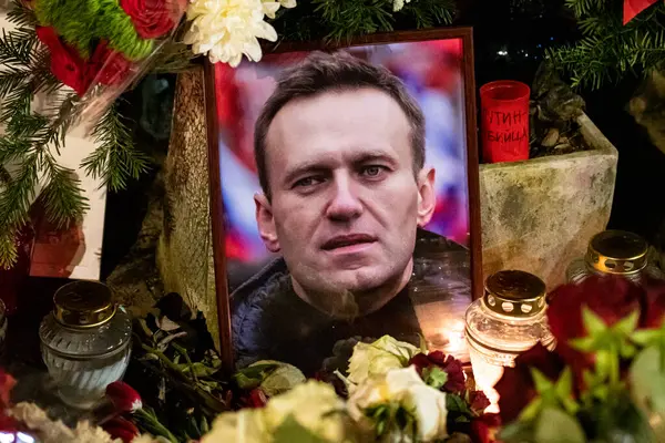 Vilnius, Lithuania - February 19 2024: Flowers and candles laid at spontaneous memorial for Russian opposition leader Alexei Navalny, who died in a remote penal colony in Kharp