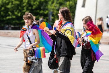 Vilnius, Litvanya - 7 Haziran 2025: Gökkuşağı renkli saçlı, yelpazeli ve LGBT + Onur Yürüyüşü sırasında bayraklı şirin gençler