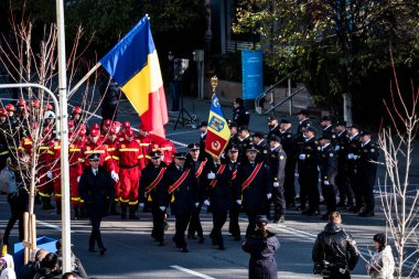 Targu-jiu 'daki ulusal geçit töreni. Üniformalı itfaiyeciler, koruyucu giysiler ve özel kırmızı itfaiye araçlarıyla.