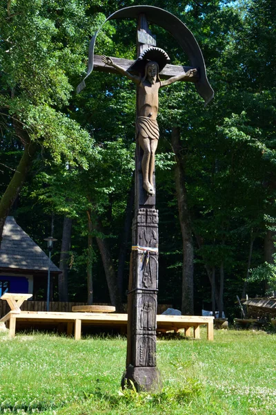 The roadside cross is carved in wood, with motifs dominated by the Orthodox cross and solar rosettes, it is located at forks and intersections of roads to ward off evil spirits