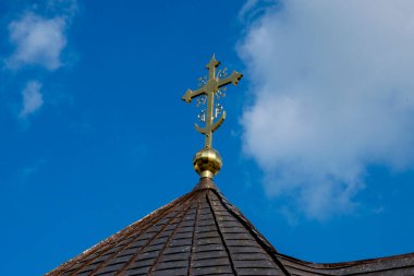  Metal Orthodox cross on church tower towards blue sky, signifies connection between heaven and earth, upward aspiration, righteousness of life illuminated by faith