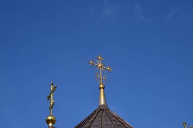  Metal Orthodox cross on church tower towards blue sky, signifies connection between heaven and earth, upward aspiration, righteousness of life illuminated by faith