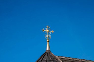  Metal Orthodox cross on church tower towards blue sky, signifies connection between heaven and earth, upward aspiration, righteousness of life illuminated by faith