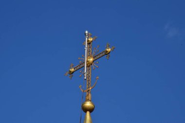  Metal Orthodox cross on church tower towards blue sky, signifies connection between heaven and earth, upward aspiration, righteousness of life illuminated by faith