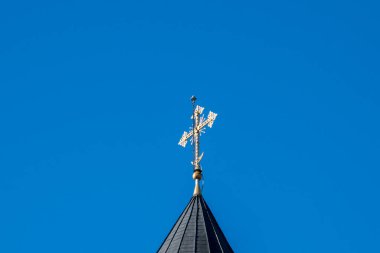  Metal Orthodox cross on church tower towards blue sky, signifies connection between heaven and earth, upward aspiration, righteousness of life illuminated by faith