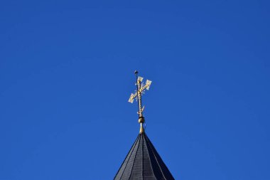  Metal Orthodox cross on church tower towards blue sky, signifies connection between heaven and earth, upward aspiration, righteousness of life illuminated by faith