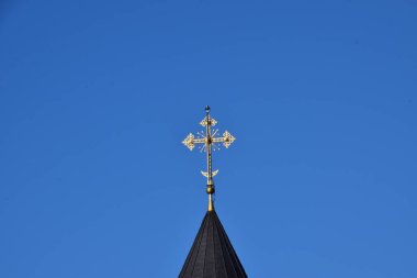  Metal Orthodox cross on church tower towards blue sky, signifies connection between heaven and earth, upward aspiration, righteousness of life illuminated by faith