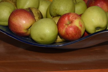 Fruits on a blue plate in the kitchen, closeup of photo