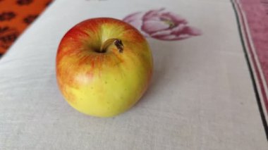 Close-up of a red and yellow apple. Macro video