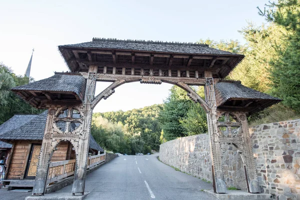 stock image Maramures Gate,built of oak wood,generally on at least three pillars carved with different Traditional floral motifs, having upper threshold of gate covered with shingles