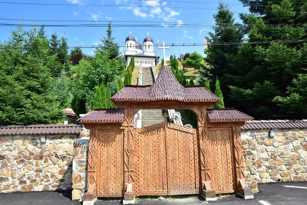 stock image Maramures Gate,built of oak wood,generally on at least three pillars carved with different Traditional floral motifs, having upper threshold of gate covered with shingles