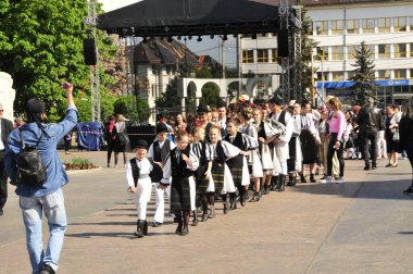 Gorj ilçesinden genç halk dansçıları geometrik ve çiçek desenli dikişli renkli geleneksel ulusal kostümler giyerler.