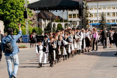 Gorj ilçesinden genç halk dansçıları geometrik ve çiçek desenli dikişli renkli geleneksel ulusal kostümler giyerler.
