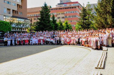 Gorj ilçesinden gelen halk müziği sanatçıları geometrik ve çiçek desenli parlak renkli geleneksel ulusal kostümler giyiyorlar..