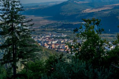 Arkasında ağaçlar olan dağlık bir arazinin güzel bir görüntüsü.