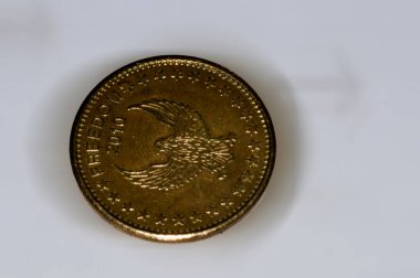 a closeup of a golden coins isolated on a white surface