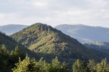 Dağları ve mavi gökyüzü olan güzel bir manzara.