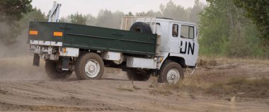 BORNE SULINOWO, WEST POMERANIAN - POLAND - 2022: A truck in colors and with a symbol of the United Nations is driving off-road