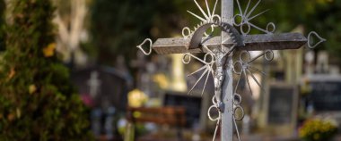 CEMETERY - Old steel crucifix and tombstones at burial site of the dead