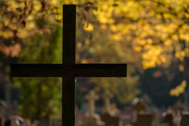 CEMETERY - Old wooden crucifix and tombstones at burial site of the dead