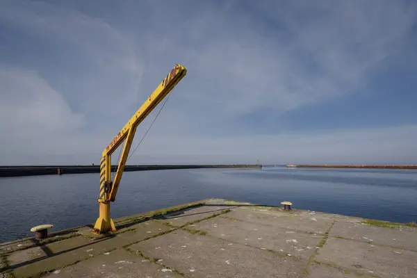 stock image MARITIME TRANSPORT - Yellow manual crane on the seaport quay