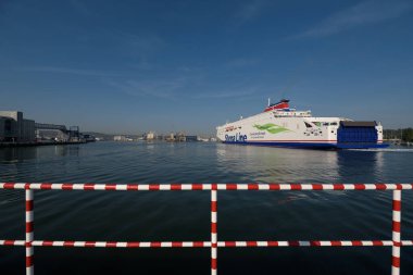 GDYNIA, POMERANIAN REGION - POLAND - 08 SEPTEMBER, 2023: Passenger ferry maneuvers in the sea port  clipart