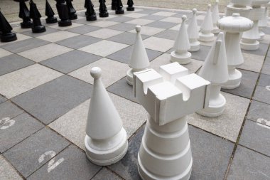 OUTDOOR CHESSBOARD - Figures and pawns on the board in the spa park clipart