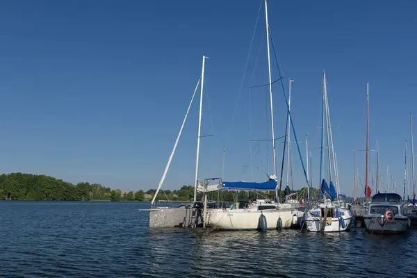 stock image CZAPLINEK, WEST POMERANIAN - POLAND - JUNE 14, 2024: LANDSCAPE BY THE LAKE - A sailboats and motor yachts moored in the marina